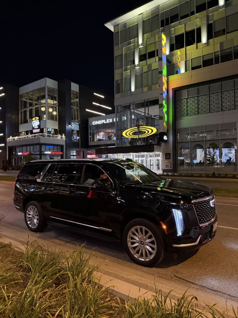 Toronto black truck limo Escalade outside Cineplex at night